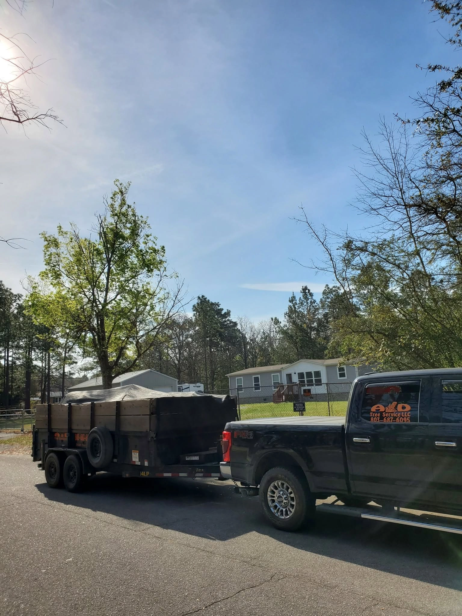 A&D black pickup tarped dump trailer mobile home chain l