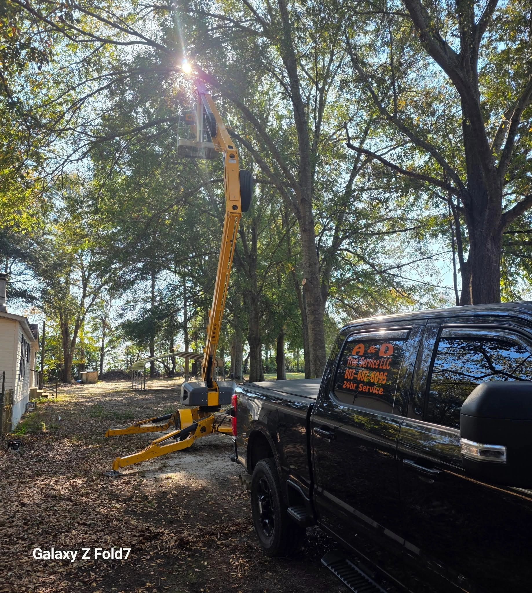 A&D black truck spider lift canopy white siding cayce
