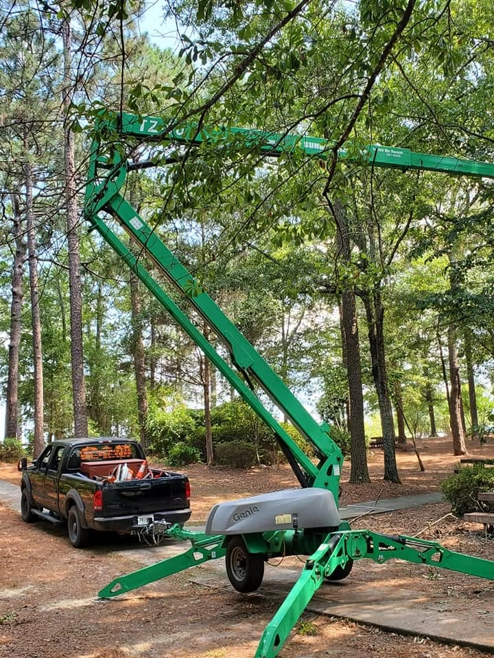 A&D genie towable boom lift oak canopy wooded lot cayce 