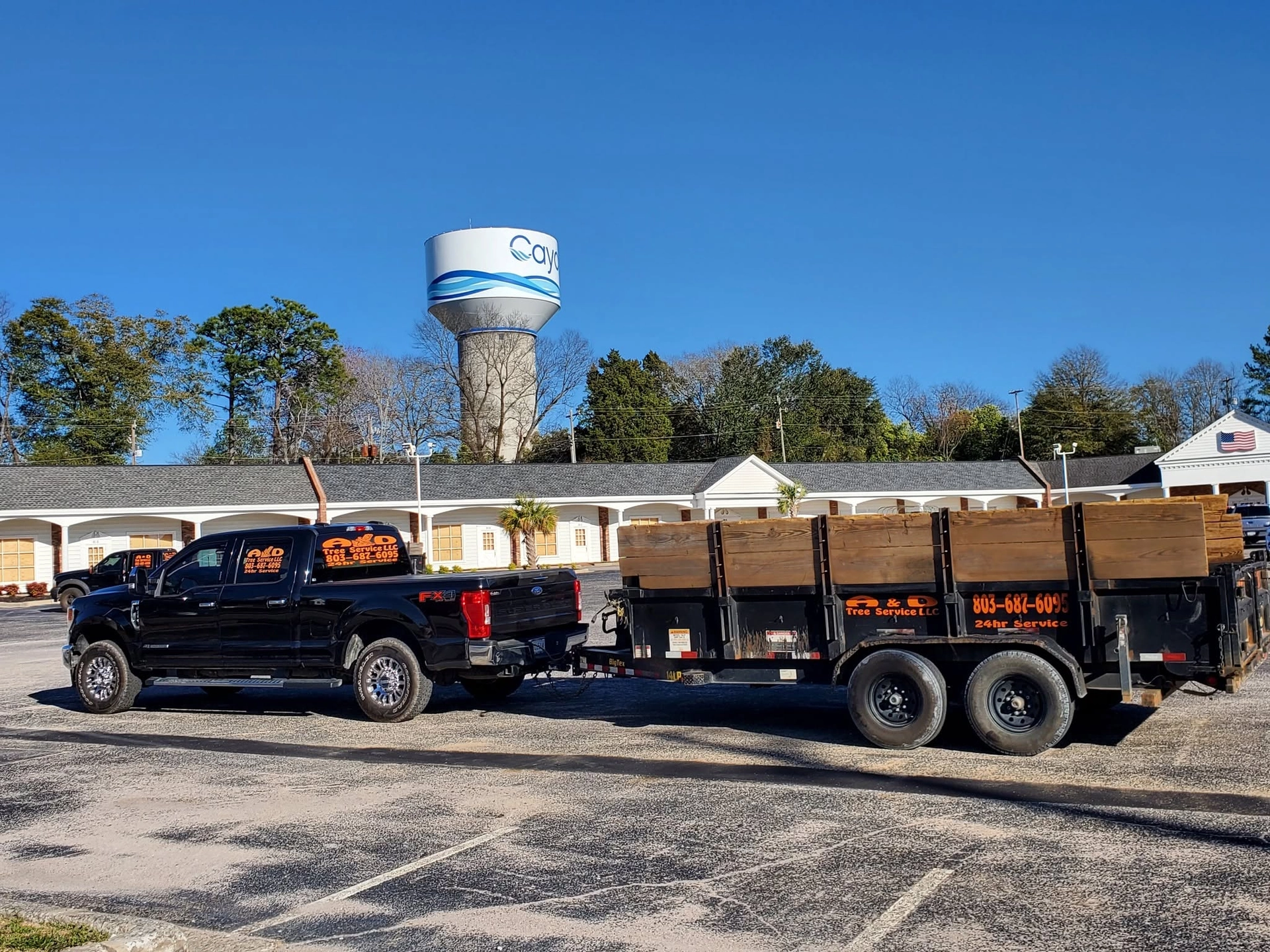 A&D lettered black ford pickup dump trailer cayce water 