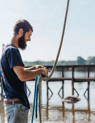 Bearded worker handling rigging rope lakeside dock cayce sc