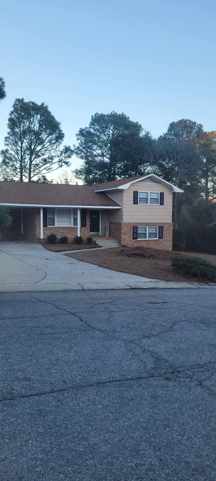 Cleared front yard after tree removal brick split level carp