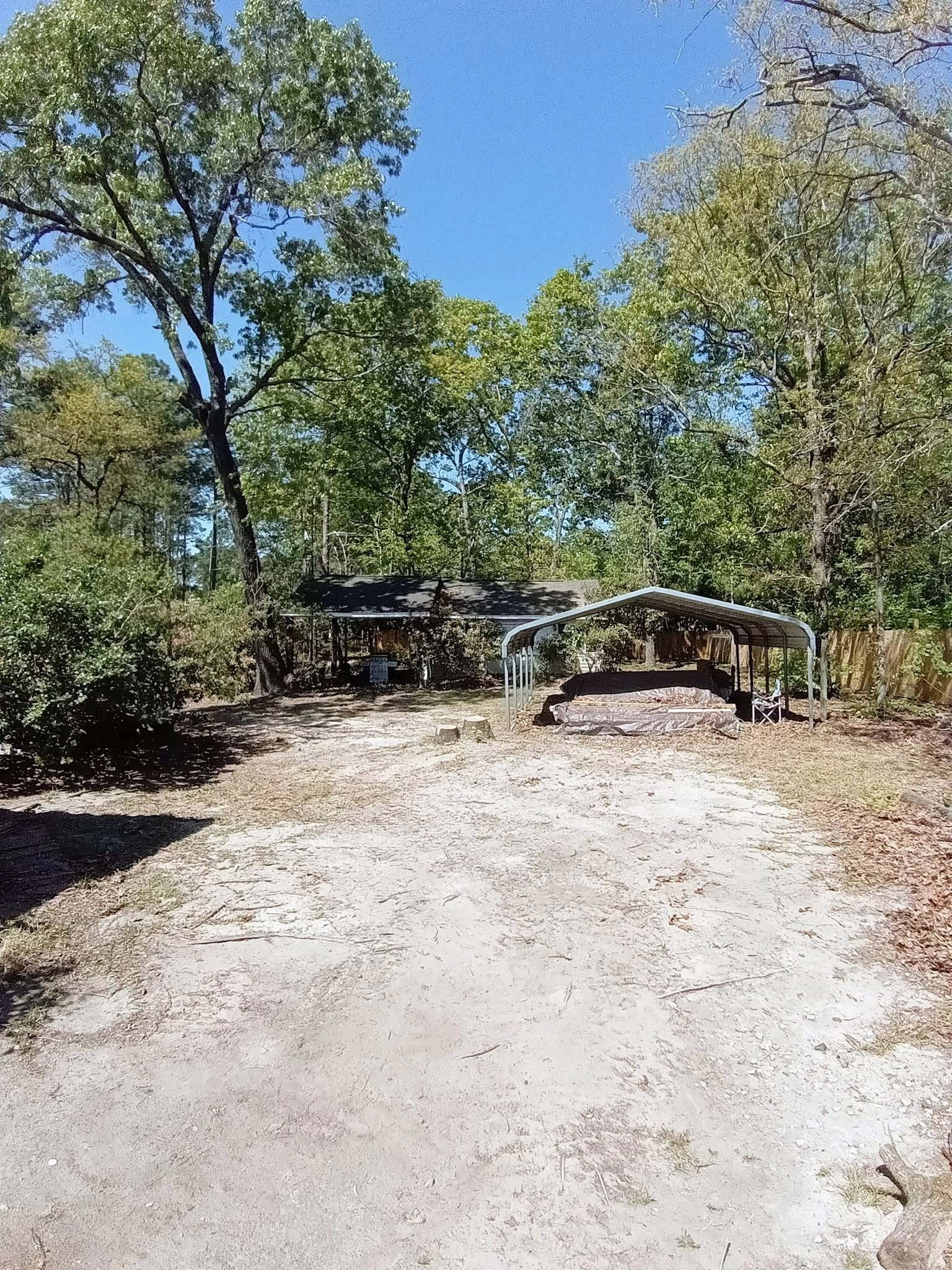 Cleared sandy backyard metal carport boat stump cayce sc