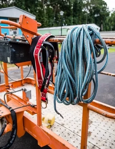 Coiled climbing rope red harness orange lift rail west colum