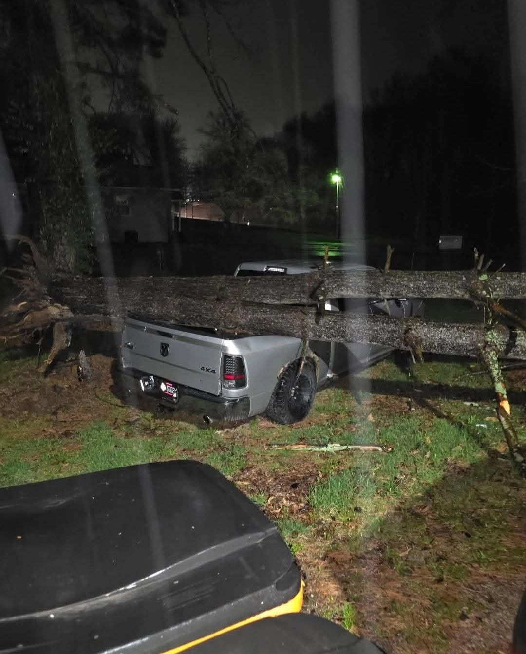 Fallen tree trunk across silver ram pickup night yard cayce 