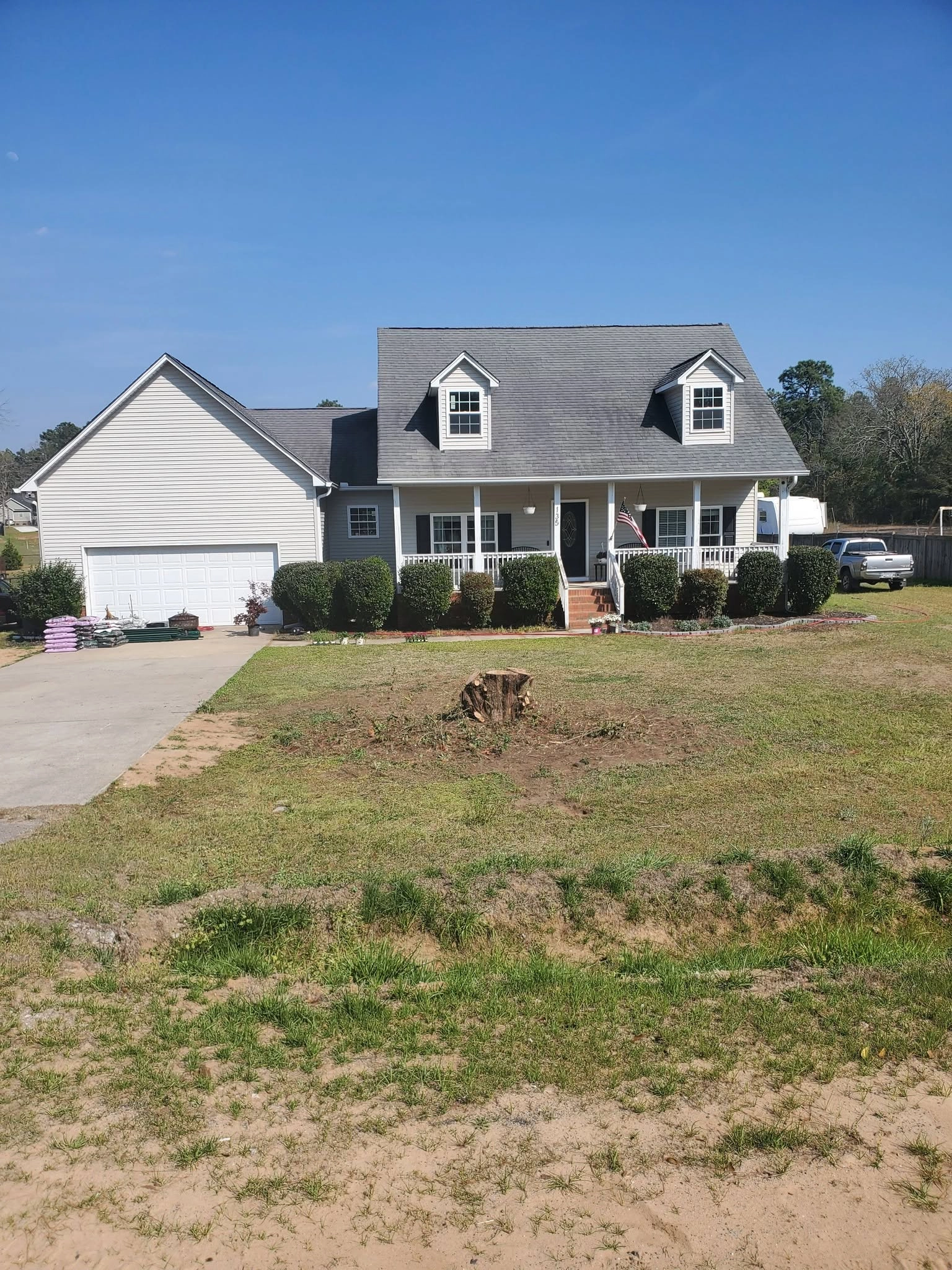 Fresh stump front lawn cape cod house dormers porch cayce sc