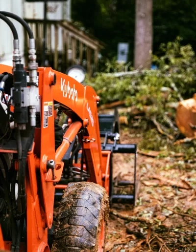Kubota loader arm hydraulic hoses close up brush pile cayce