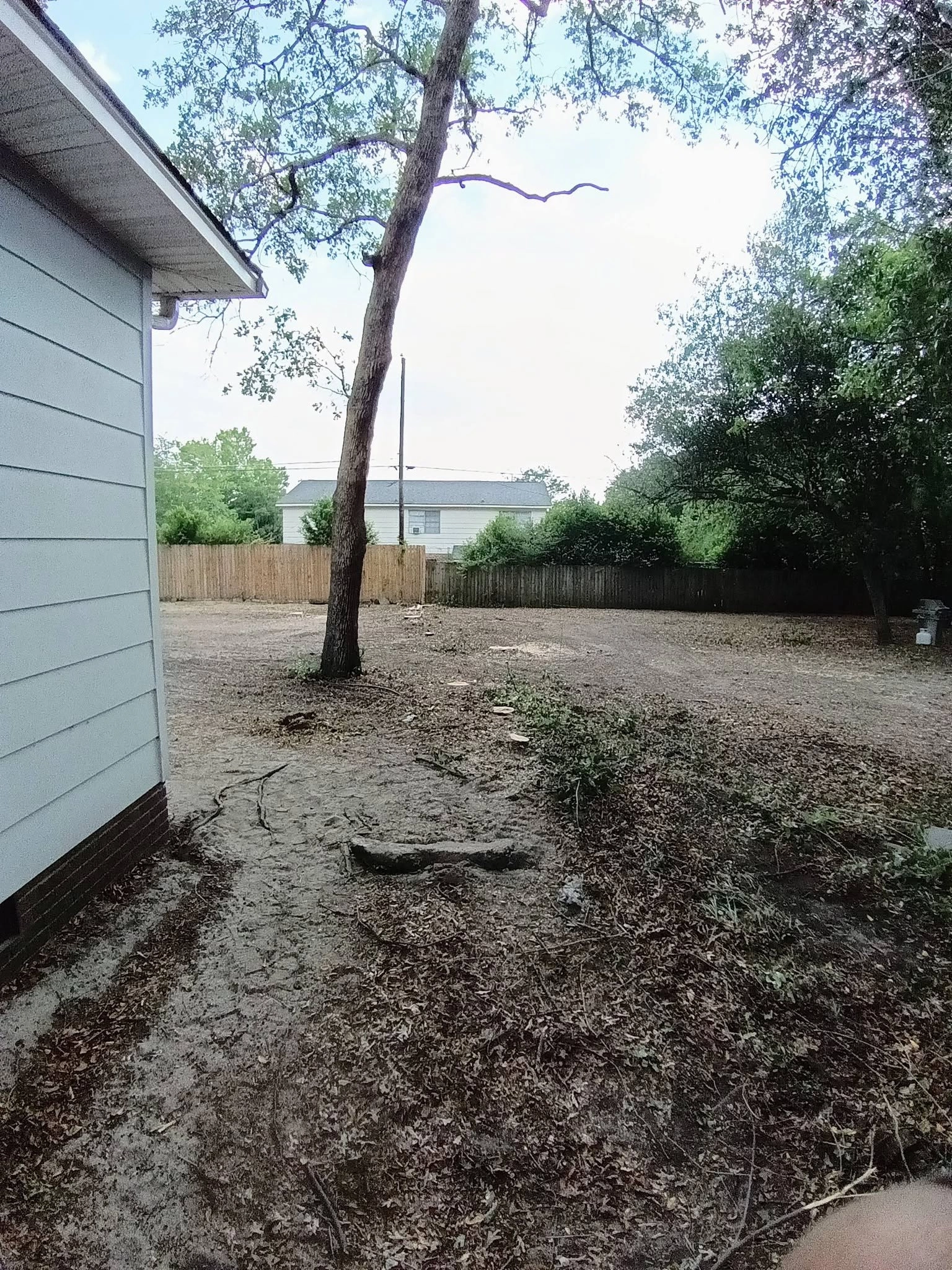 Leaning oak sandy backyard wood privacy fence house corner c