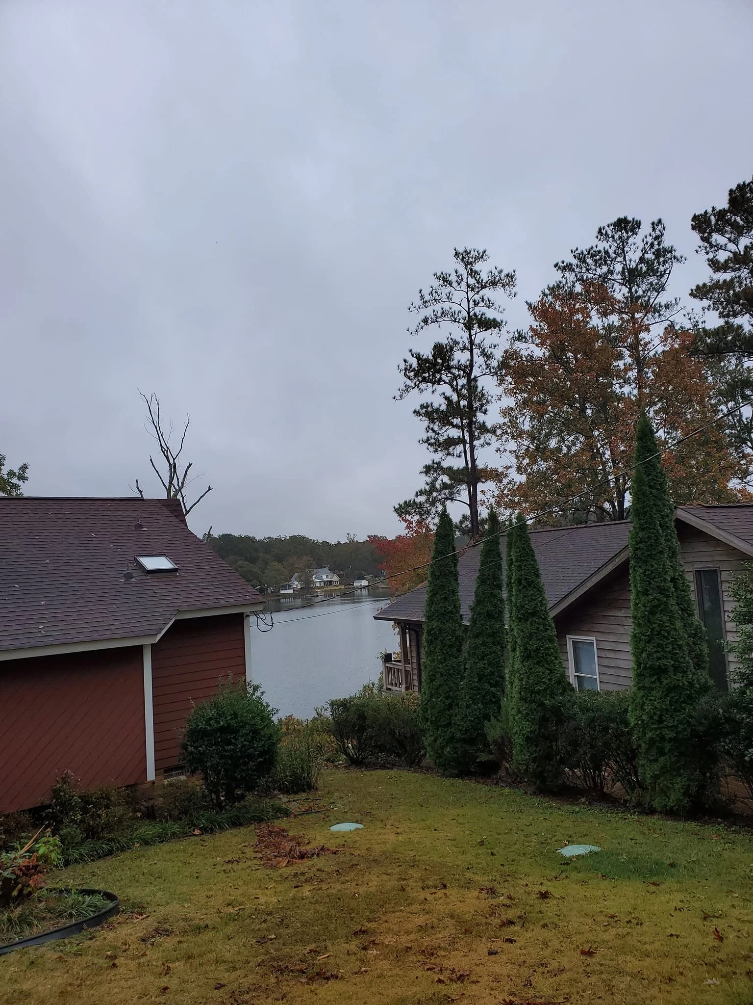 Overcast lakefront yard red house cypress row cayce