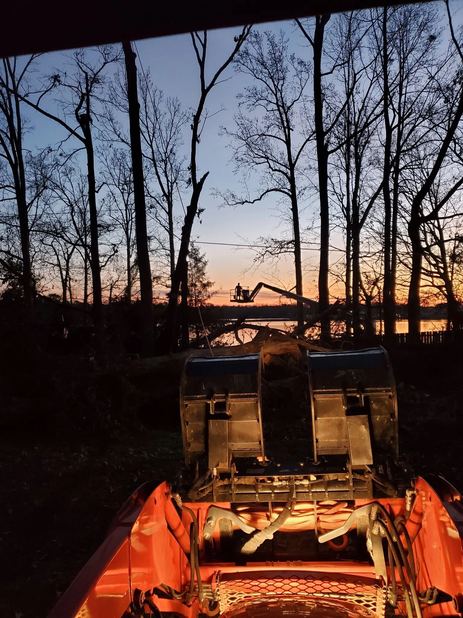 Skid steer grapple cab view dusk bucket lift lakeside cayce