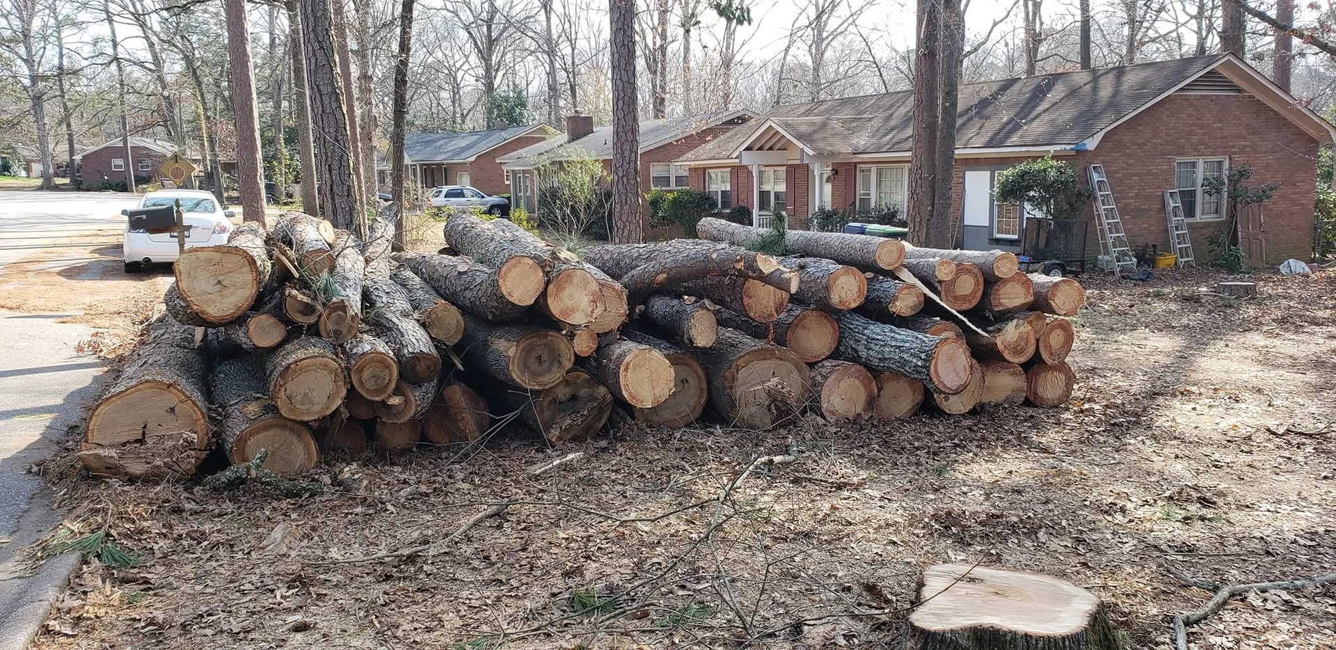 Stacked pine logs curbside brick ranch flush stump cayce sc