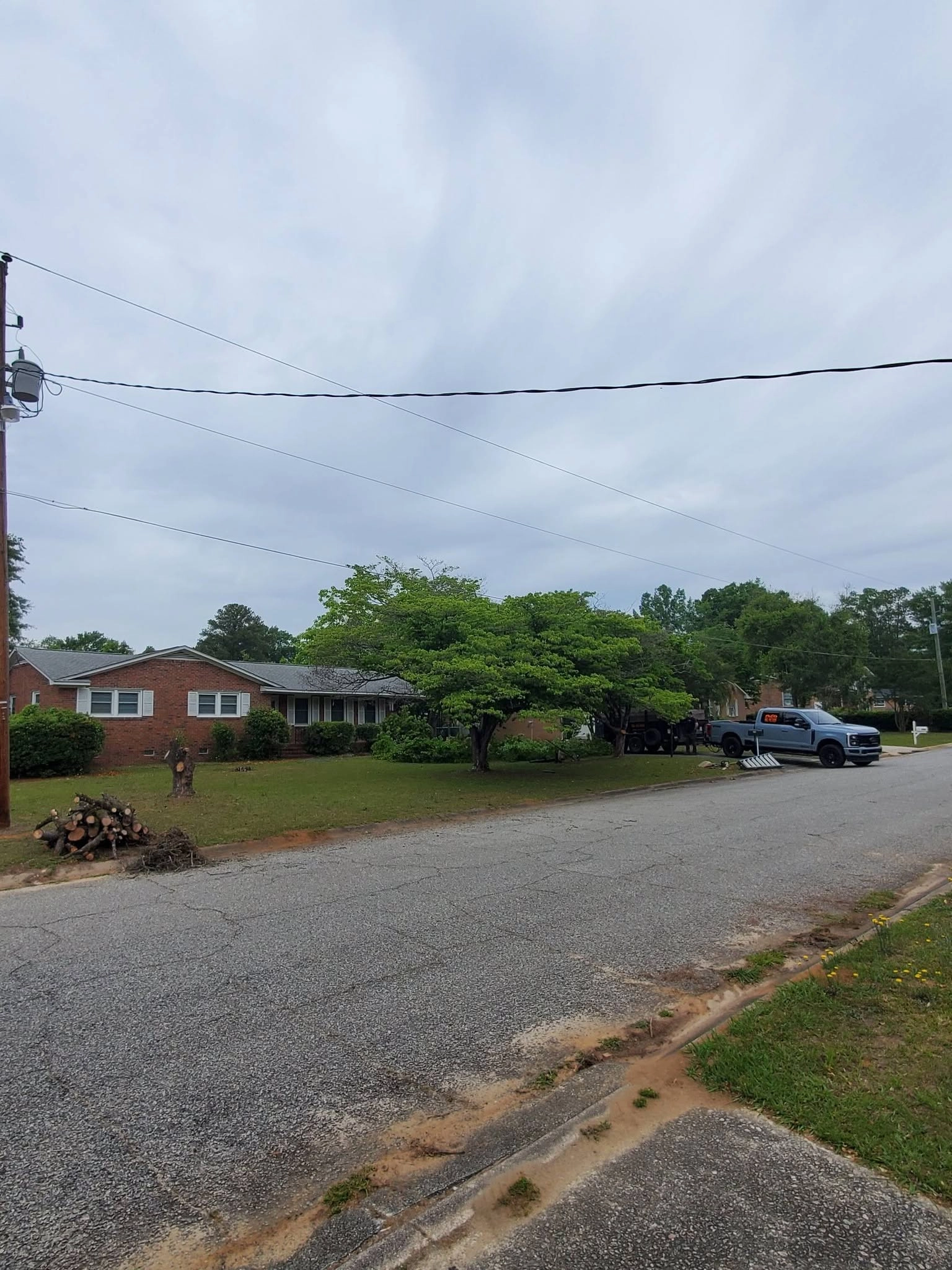 Street view brick ranch log pile curb stump gray truck cayce