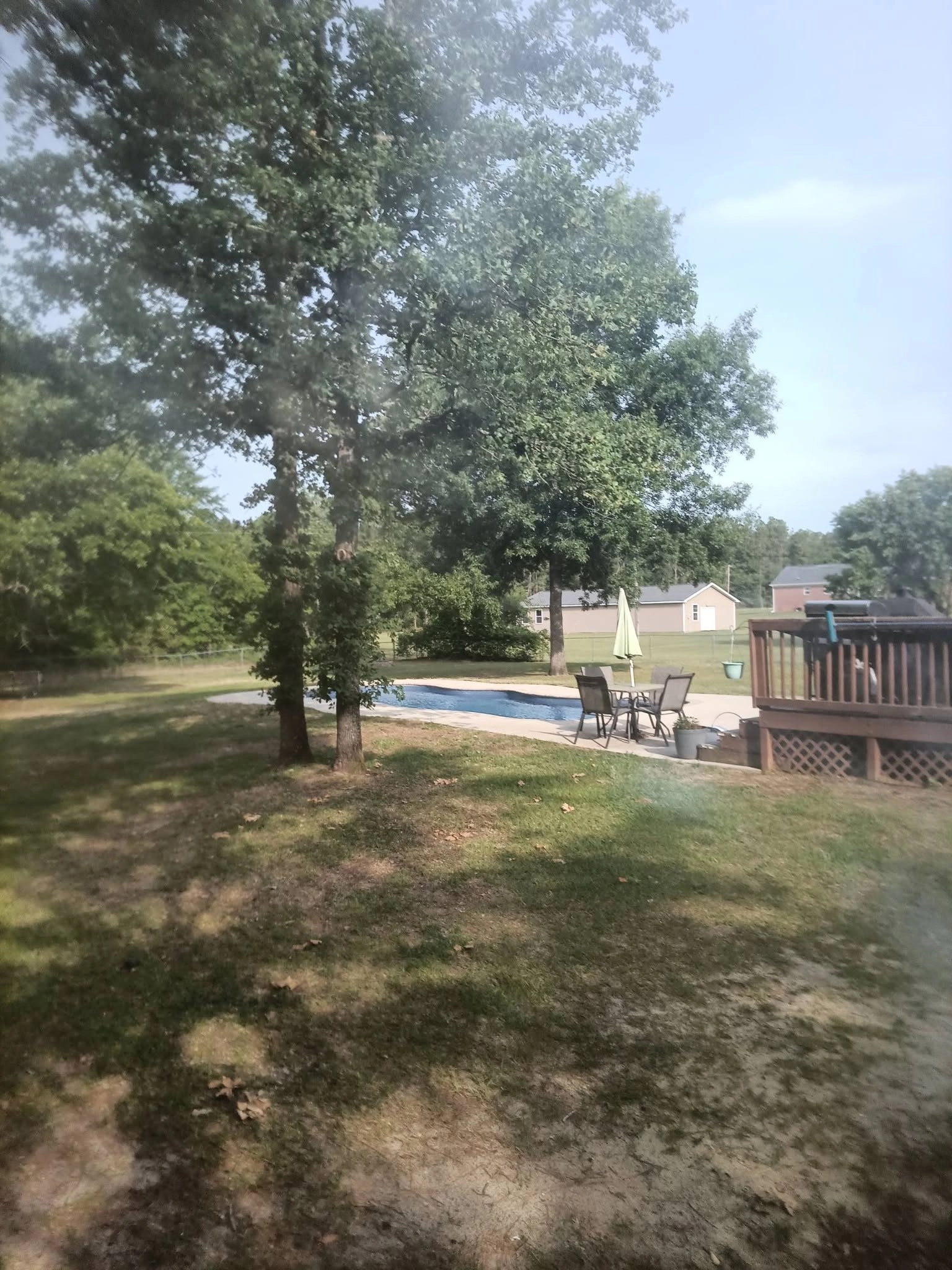 Twin oaks shading backyard pool wood deck cayce sc